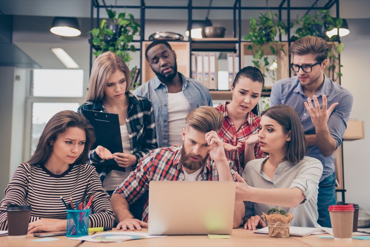 group of friends struggling to answer "would you rather" questions from their computer