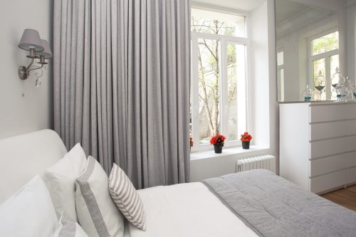 gray and white bedroom with gray curtains