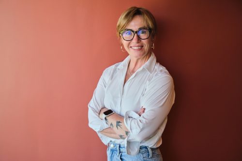 mature businesswoman in highwaisted jeans and button-down