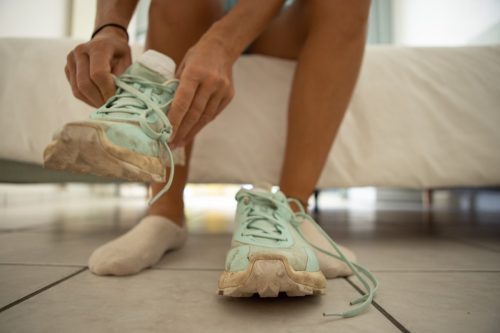 Close up of a woman putting her sport shoes on