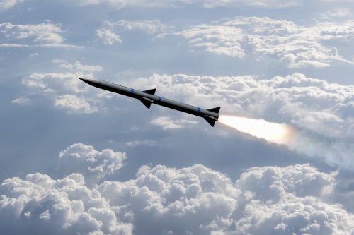 A combat rocket is flying above the clouds,