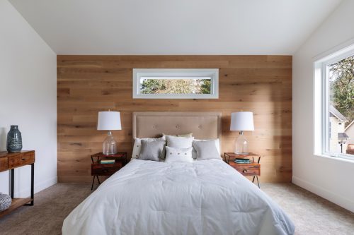Rustic-style bedroom with wood wall and matching nightstands