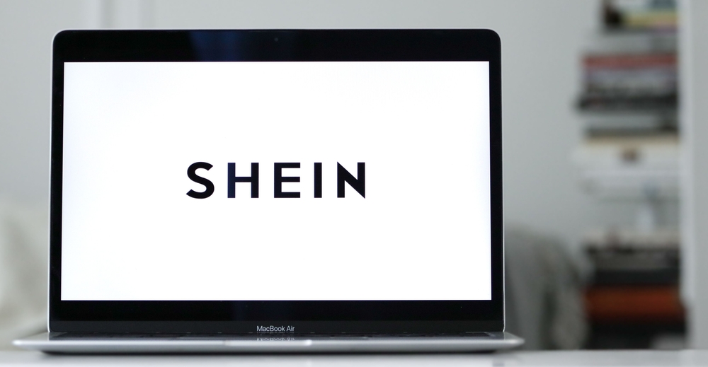 The SHEIN logo on a laptop screen