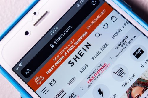 A close up of a phone screen visiting the SHEIN website