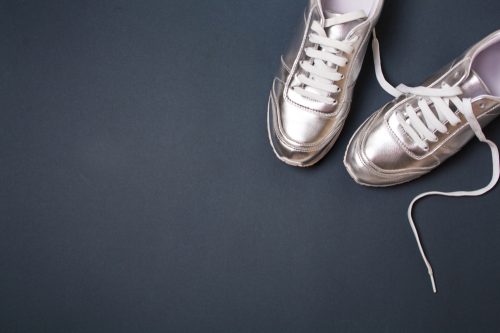 Silver sneakers on dark gray background