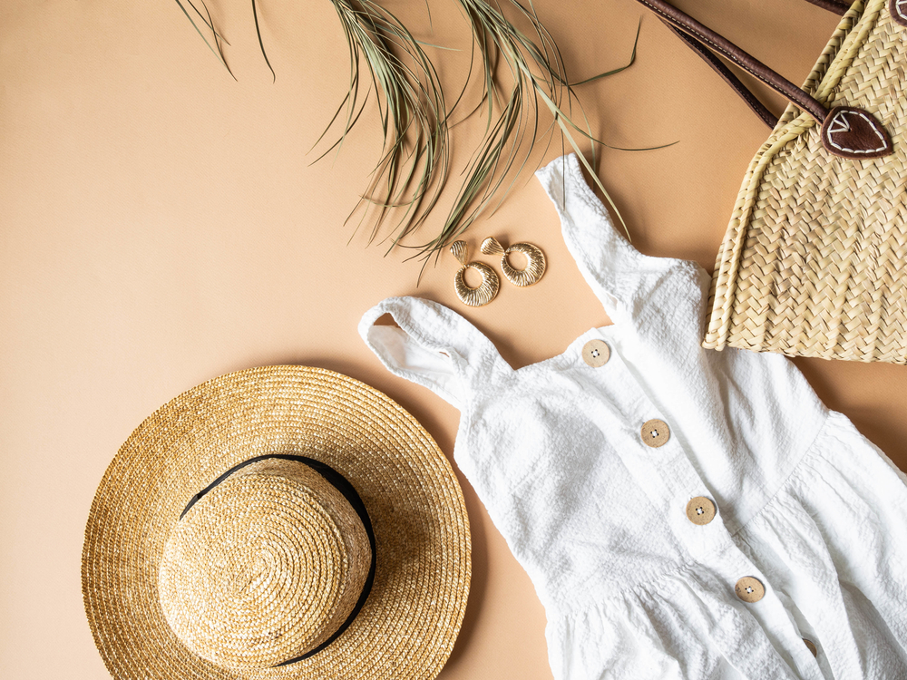 Summer sundress style concept with straw hat, tote bag and earrings