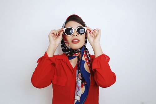 Stylish young Asian woman with retro style sunglasses and head scarf