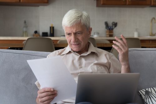 older man reading complicated contract