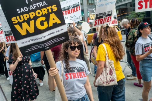 protester holding sag-aftra sign during WGA strike