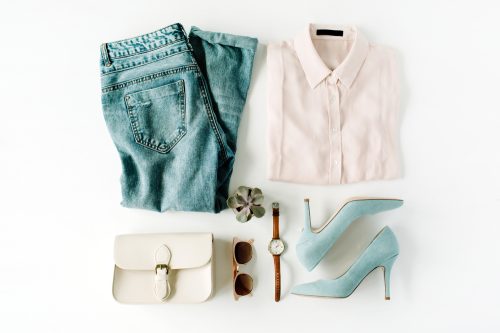 Style concept outfit with white button-down shirt, jeans, purse, sunglasses, and blue suede heels