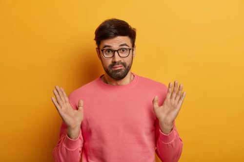 man with his hands up unable to answer unanswerable questions