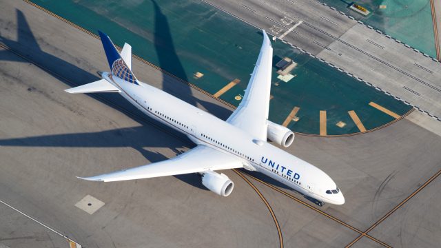 A United Airlines plane on the runway at an airport