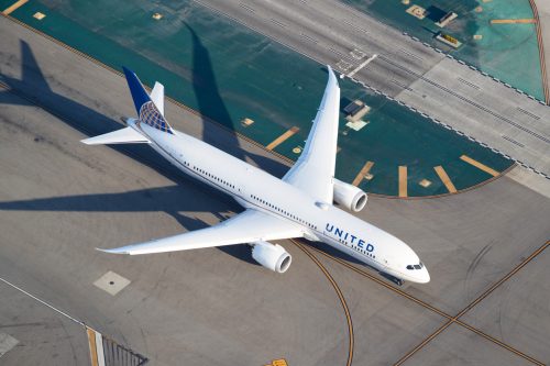A United Airlines plane on the runway at an airport