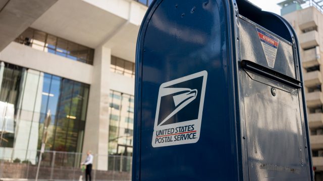 A close up of a USPS mailbox