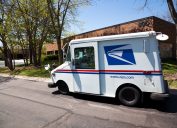 United States Postal Service delivery truck distributing mail in office complex in Northbrook - suburban town north of Chicago.