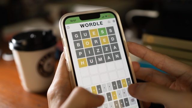 A mobile user playing Wordle, a popular word game.