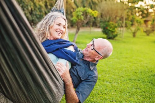 mature man and woman enjoying time together in their hammock