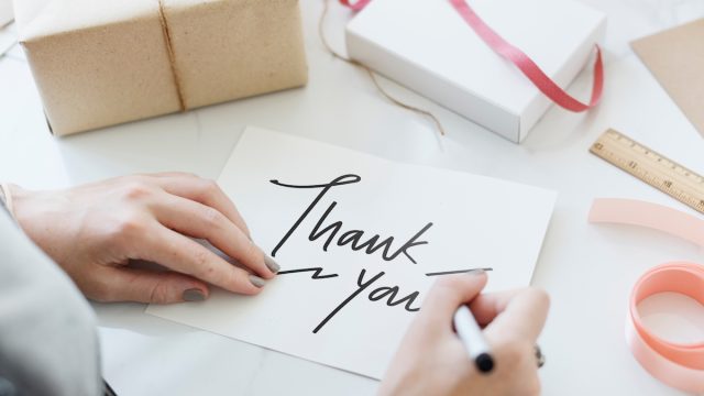Woman writing a Thank You card