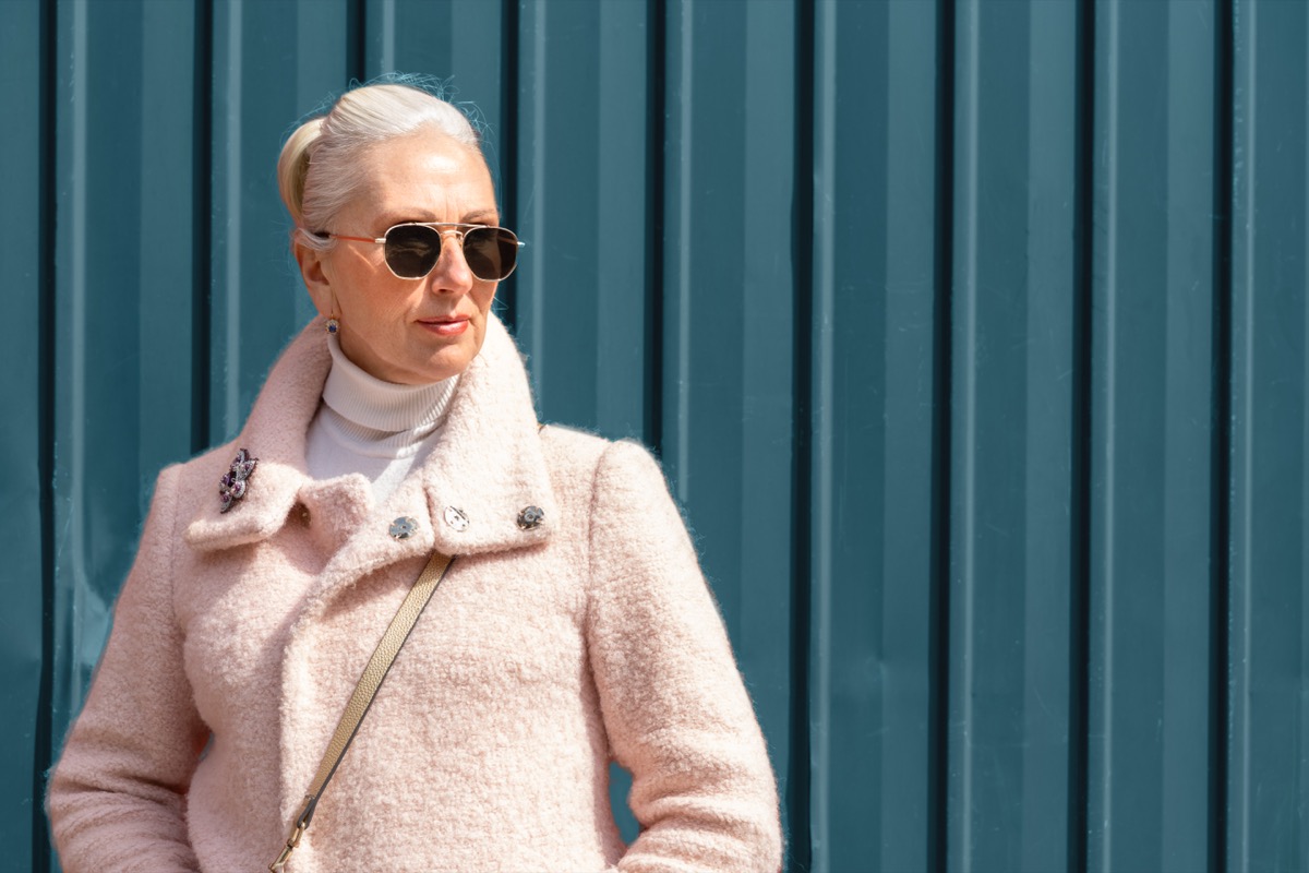 Chic Older Woman in Sunglasses and Pink coat