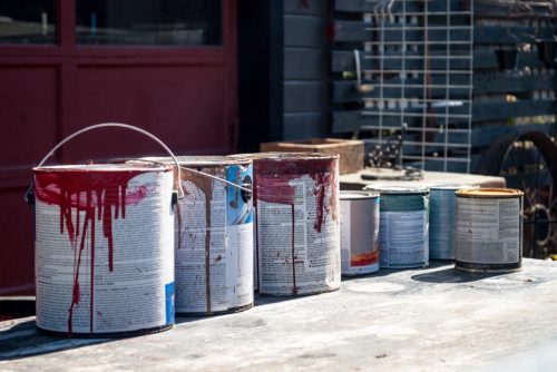 https://bestlifeonline.com/wp-content/uploads/sites/3/2023/08/Old-Paint-Cans-in-Front-of-Garage.jpg?quality=82&strip=all&w=500