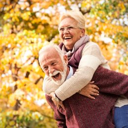 Older Man and Woman Enjoying Fall Scenery