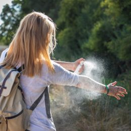 Woman Spraying Bug Spray