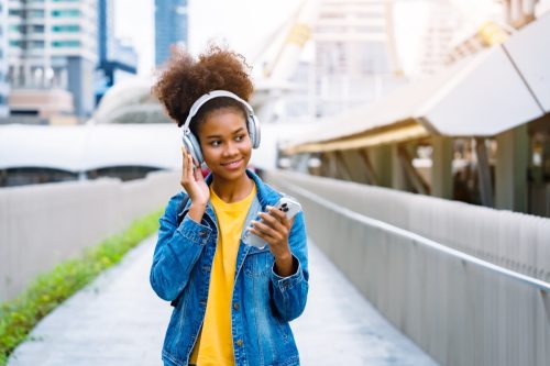 Young Girl Enjoying Music While Walking