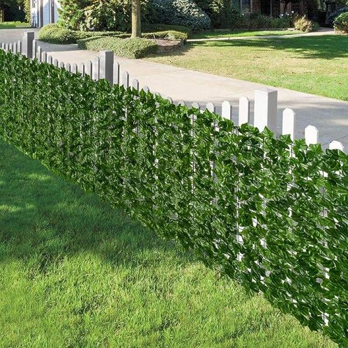 Amazon's faux ivy privacy fence, shown on a white picket fence