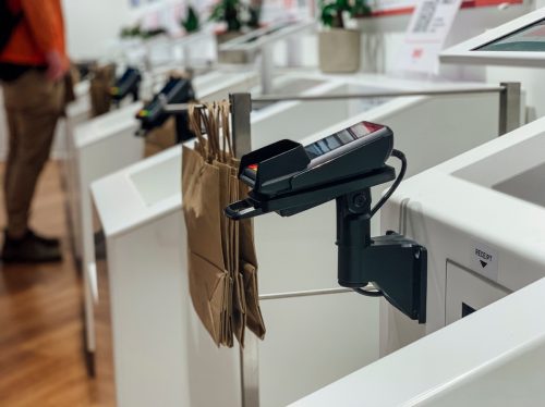 A medium shot of a card reader at a self checkout in a store.