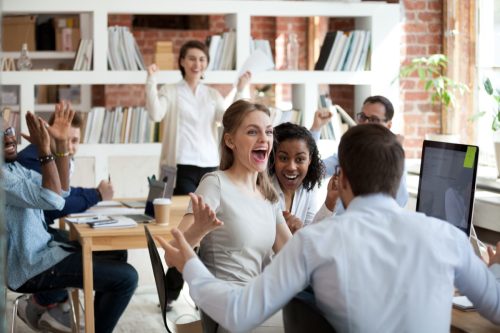 Group of coworkers celebrating in an office