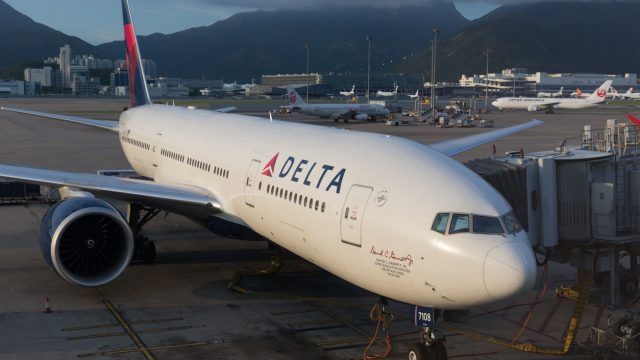 A Delta Air Lines plane sitting at a gate at an airport
