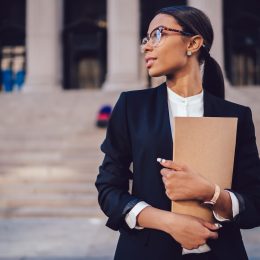 Female lawyer standing in front of a court house