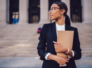 Female lawyer standing in front of a court house
