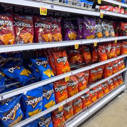 Los Angeles, California, United States - 02-01-2023: A view of several shelves dedicated to packages of Doritos chips, on display at a local grocery store.