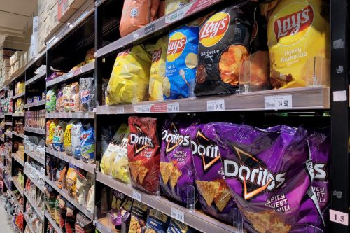 Various local and imported brands of flavoured chips and snacks on store shelf in Jaya Grocer store. Jaya Grocer is the coolest fresh premium supermarket in Malaysia.