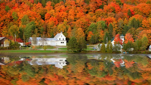 Danville Vermont church from Joes pond with beautiful fall foliage in the background