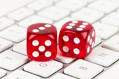 two red dice on top of a keyboard