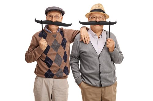 old men posing with big fake moustaches isolated on white background