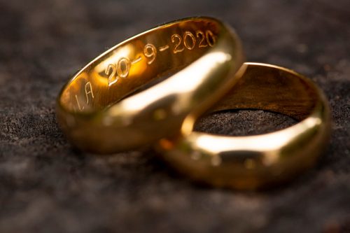 gold wedding rings with detail of the dates engraved in the ring