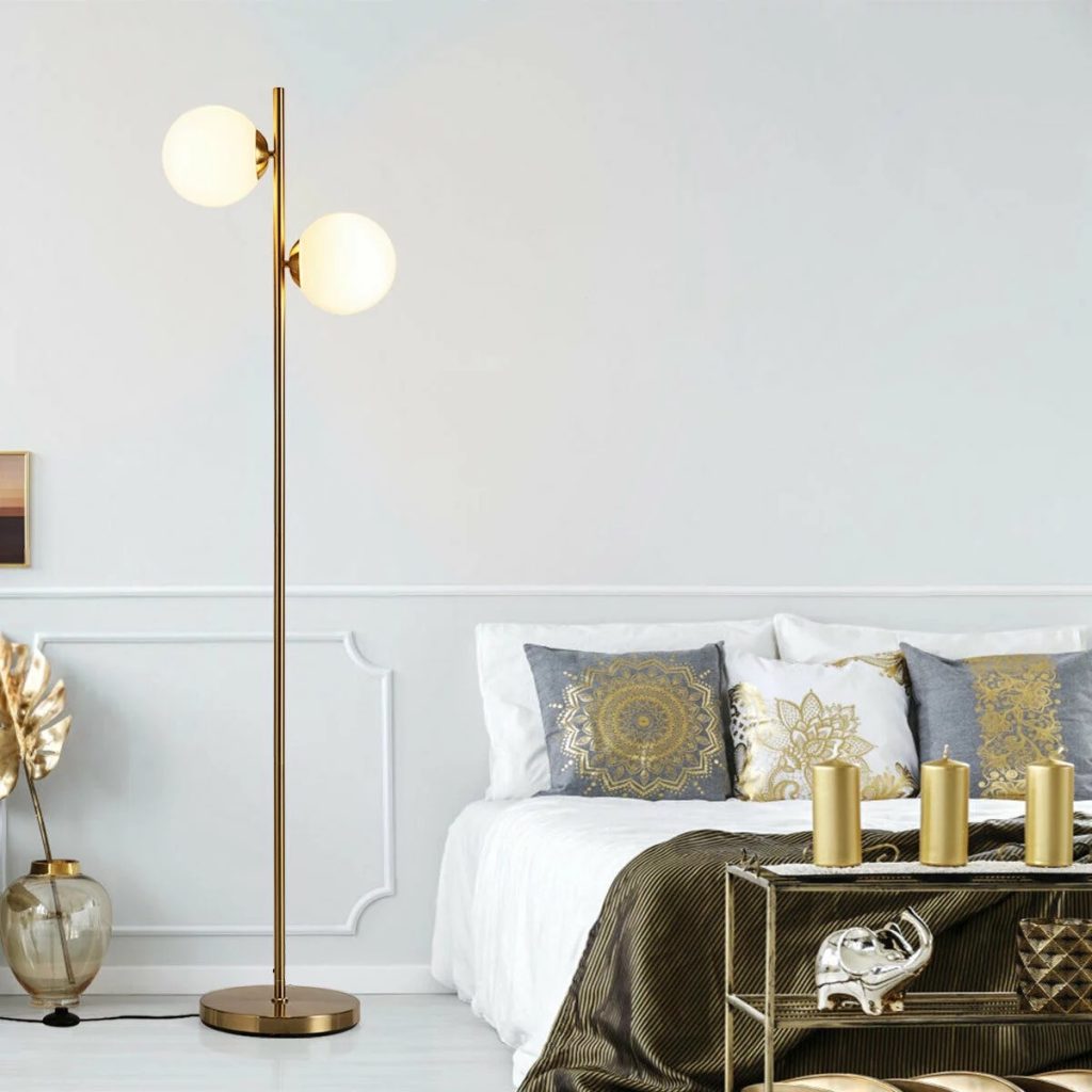 A Gymax floor lamp illuminated in a bedroom