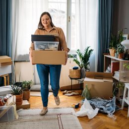 woman carrying boxes with personal belongings