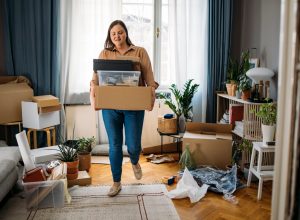 woman carrying boxes with personal belongings