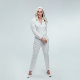 older woman in white jumpsuit