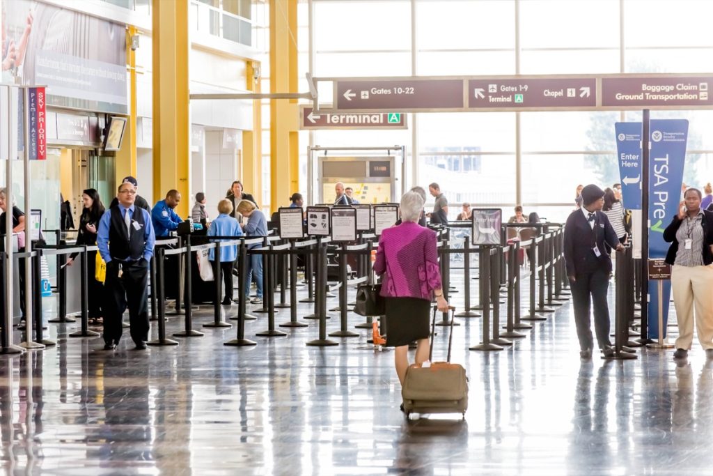 woman waling through airport to security checkpoint