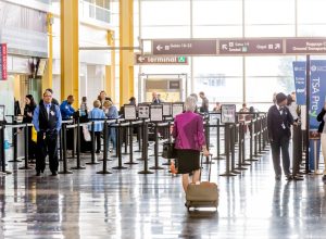 woman waling through airport to security checkpoint