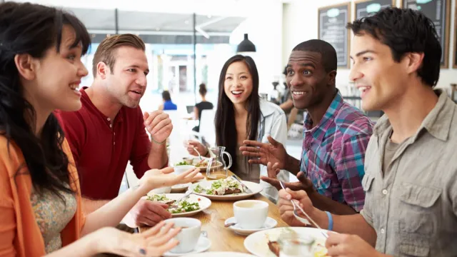 Two women and three men having lunch and talking