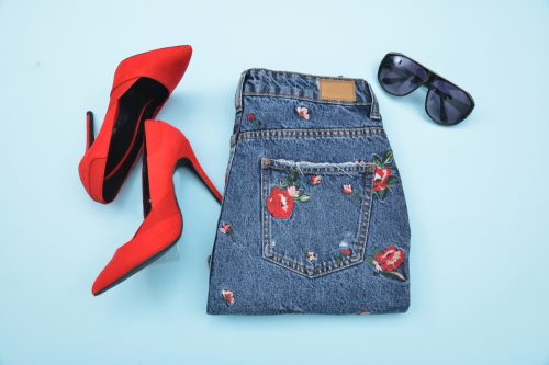 Embroidered jeans with red heels and sunglasses