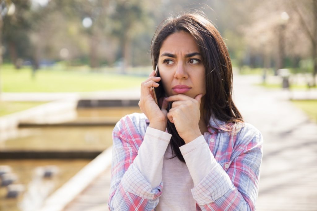 concerned young woman on cellphone