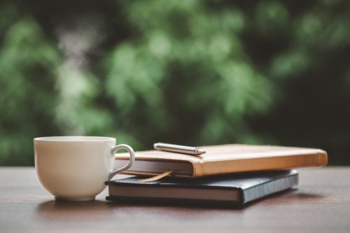 coffee, journals, and pen