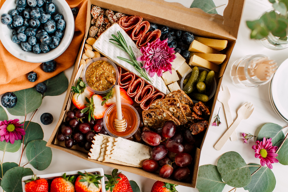 Beautiful charcuterie cheese board with nuts, meats, and fruits